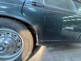 an image of a car with a flat tire on the side of the road