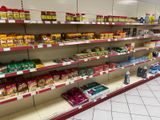 many shelves in the store that have various types of food on them
