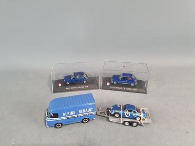three toy trucks that are next to each other on a table