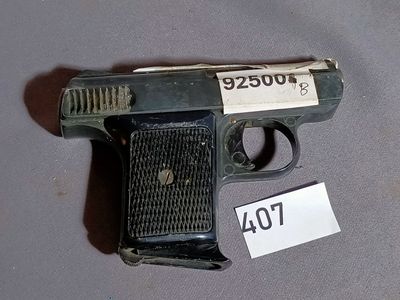 a gun that is on a table with a price tag