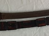 pair of old wooden swords on a white surface