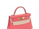 a pink and beige handbag on a white background