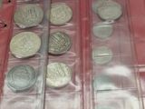 a lot of coins in a plastic case on a table