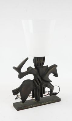 a lamp that has a horse and rider on it