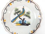 a plate with a peacock painted on it