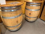 two wine barrels sitting on the floor next to each other