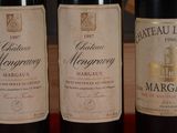 three bottles of wine sitting on top of a table next to each other
