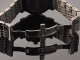 a close up of a watch on a reflective surface