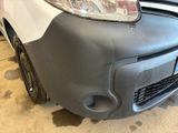 a car that has been painted gray and is parked in a garage