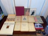 several books on a table with a tv in the background