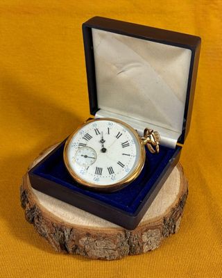 a small wooden box with a clock inside of it