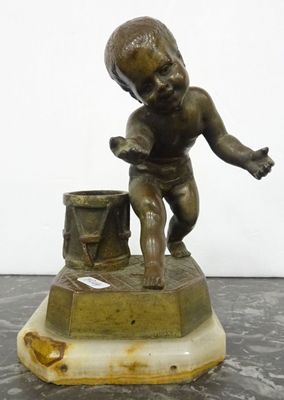bronze figurine of a boy with a bucket on a marble base