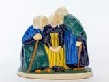 une image représentant une figurine de trois personnes tenant une canne