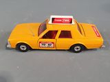 a yellow toy car with a sign on top of it