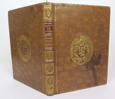 an old book with a gold cover and a cross on the front