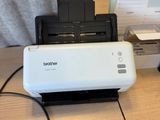 a printer sitting on a desk next to a monitor