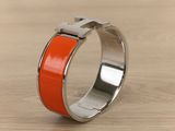 a ring with an orange stripe on it on a table