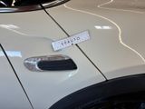 a close up of a car door handle with a sticker on it