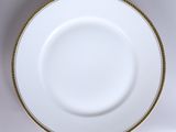 an image of a white plate with gold trim on a white background