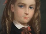 portrait of a young girl in a black dress with a red bow
