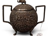an old metal teapot with a lid and handle on a white background