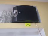 a black and white radio on a shelf in a kitchen