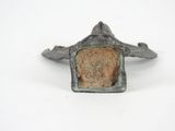 an image of a bronze bird with a stone in its beak