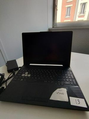 a laptop that is sitting on a table with a charger
