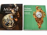 two books on a white table with a gold clock and a green book cover