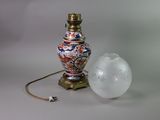 a lamp that is sitting next to a glass ball