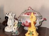 three different figurines sitting on a table next to a bowl