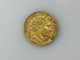 a close up of a gold coin on a white surface