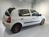 a small white car parked in a white room