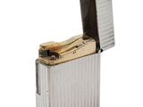 silver lighter with a lighter in the middle of it on a white background