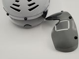 a helmet and a pair of ear buds sitting on a table