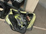 a bag of tools sitting on the floor next to a workbench