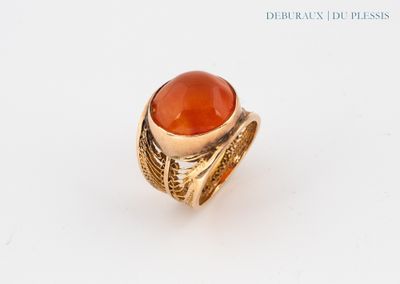 an image of a gold ring with a carnel stone in the center