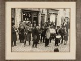 an old photo of a group of men standing in front of a building
