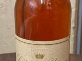 a bottle of whiskey sitting on a table next to a bottle of wine