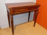 a small wooden table with a drawer on top of it