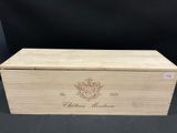 a wooden box with a crest on the lid