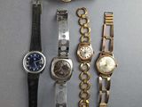 a lot of watches that are sitting on a table
