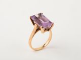 an image of a gold ring with an amethorate stone