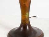 a glass vase with a painting on it sitting on a table