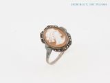 a close up of a ring with a picture of a woman on it