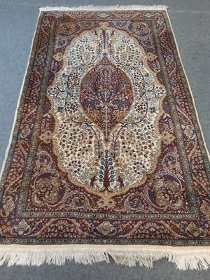 a large persian rug with a floral design on a blue ground