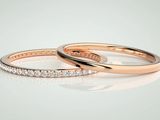 two rose gold wedding rings with diamonds on a white background