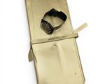 gold leather watch case with a watch on it and a watch in it