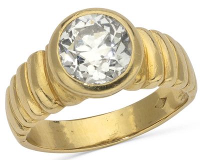 a close up of a gold ring with a diamond on it