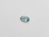 a close up of a blue topaz stone on a white surface
